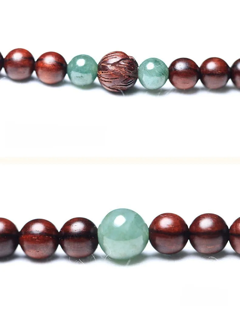 Carved rosewood bead bracelet with Hotian jade pendant showing wood grain texture