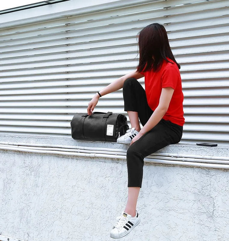 Black waterproof sports fitness bag with separate shoe compartment and diagonal strap.