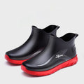 Men's short PVC wellington boots in beige and black colours with a flat non-slip sole.