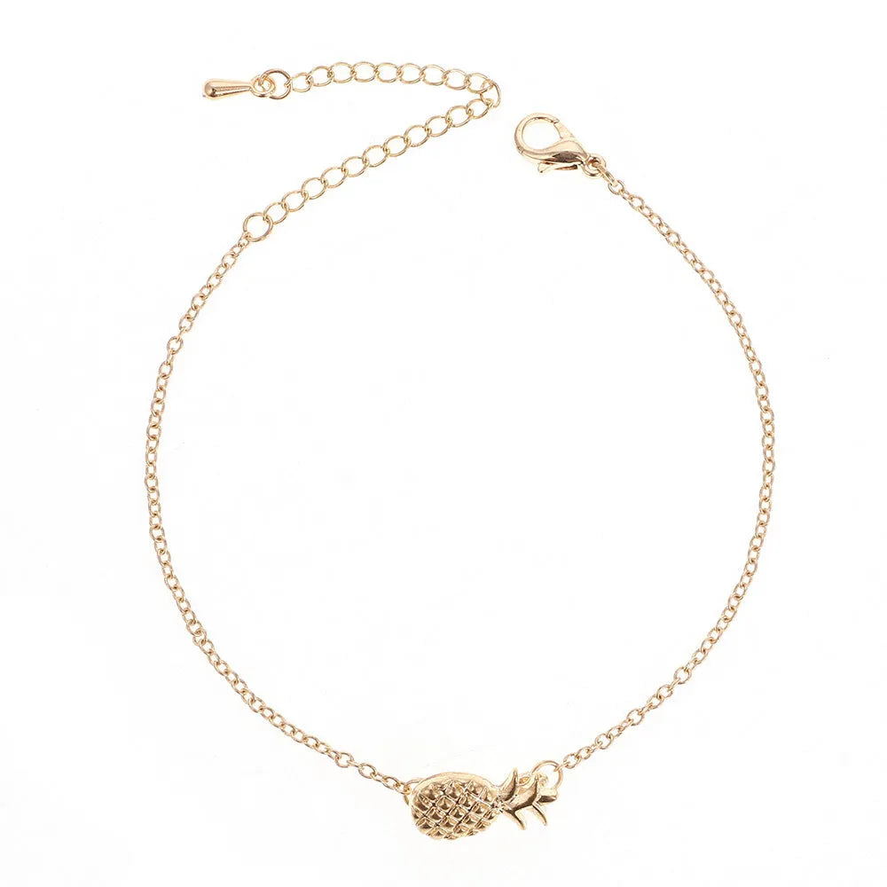 Women's alloy bracelet with a simple pineapple charm in a choice of gold or silver metallic finish.