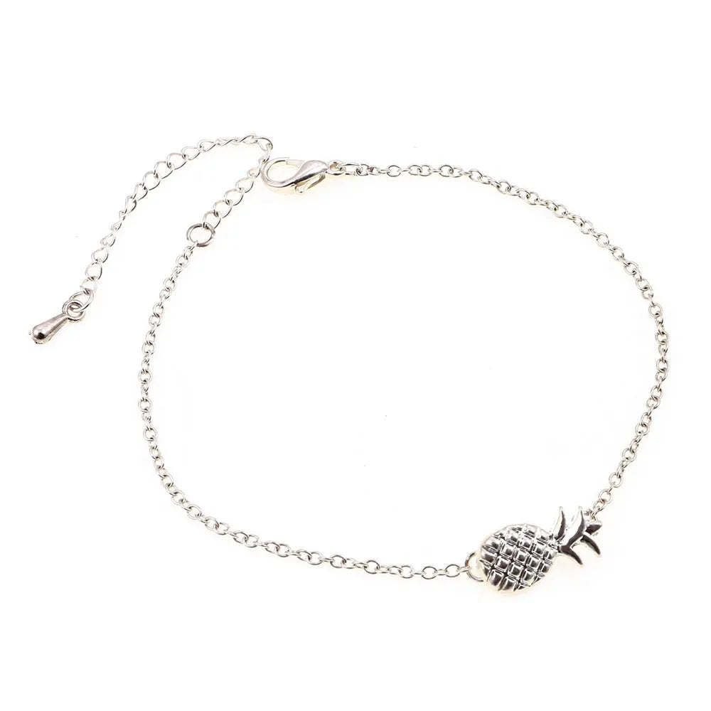 Women's alloy bracelet with a simple pineapple charm in a choice of gold or silver metallic finish.