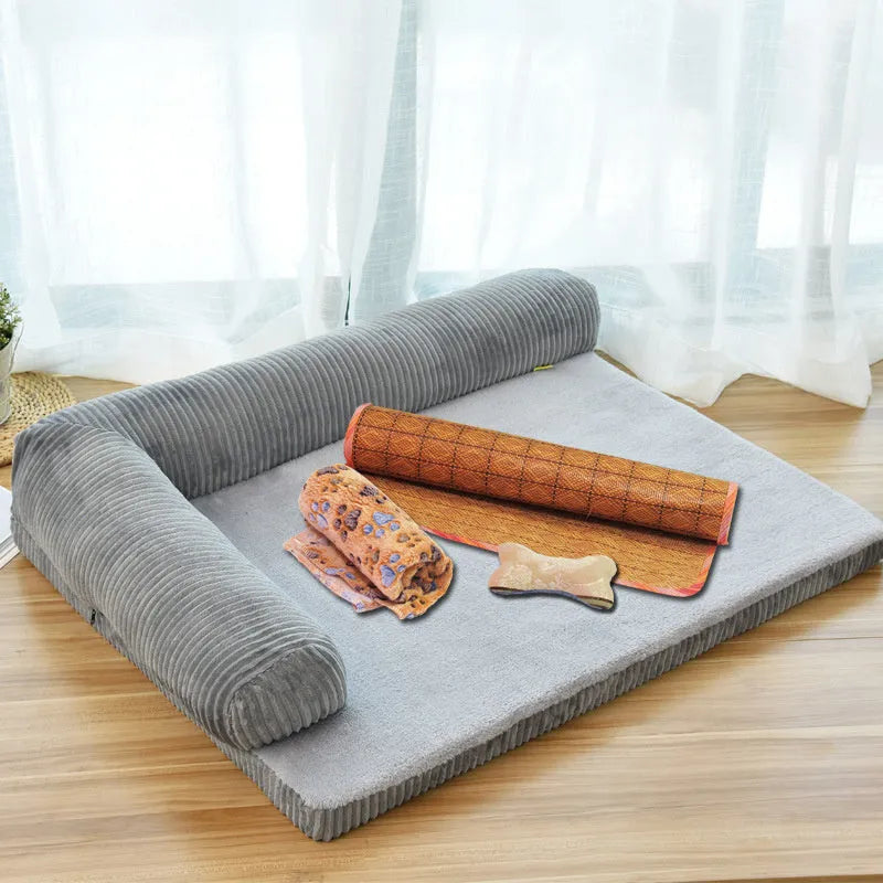 A large grey corduroy dog sofa bed with bilateral sides and a non-slip base on a wooden floor.