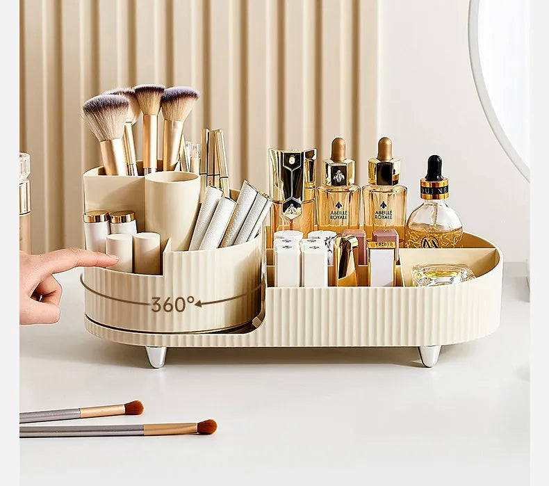 Rotating cream and black cosmetics organiser box holding makeup brushes and lipsticks on a table.
