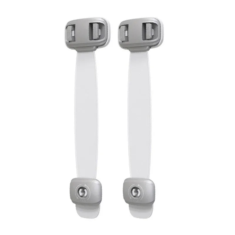 Grey adjustable child safety strap lock with adhesive pads, shown securing a kitchen cabinet door.