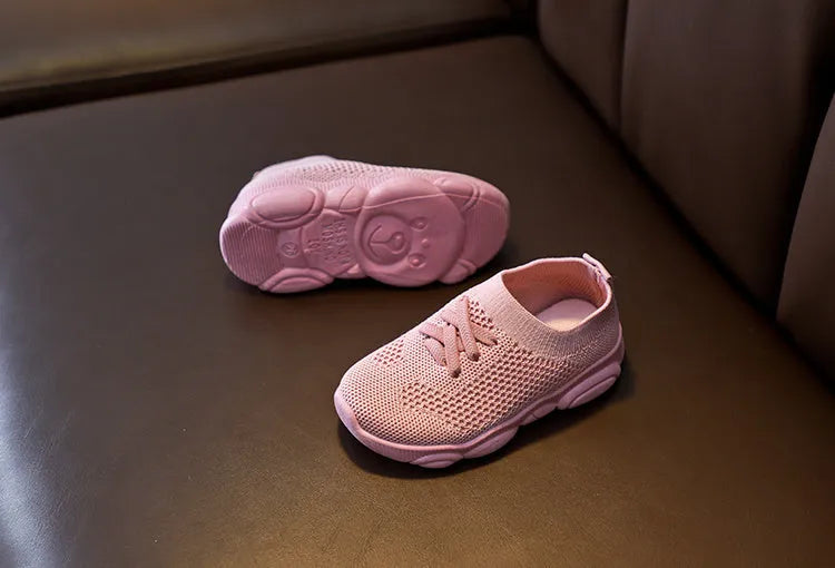 Children's lazy slip-on shoes in white, black, pink, or grey with fabric upper and rubber sole.