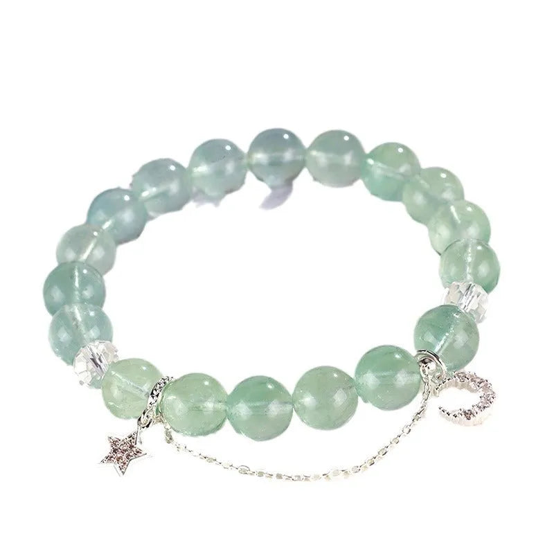 Green fluorite bracelet with star and moon princess designs on wrist