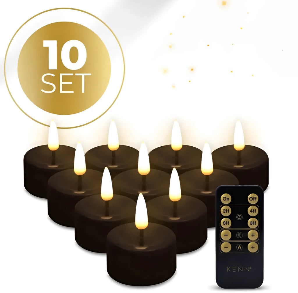 Set of four black flameless LED tealight candles on a surface.
