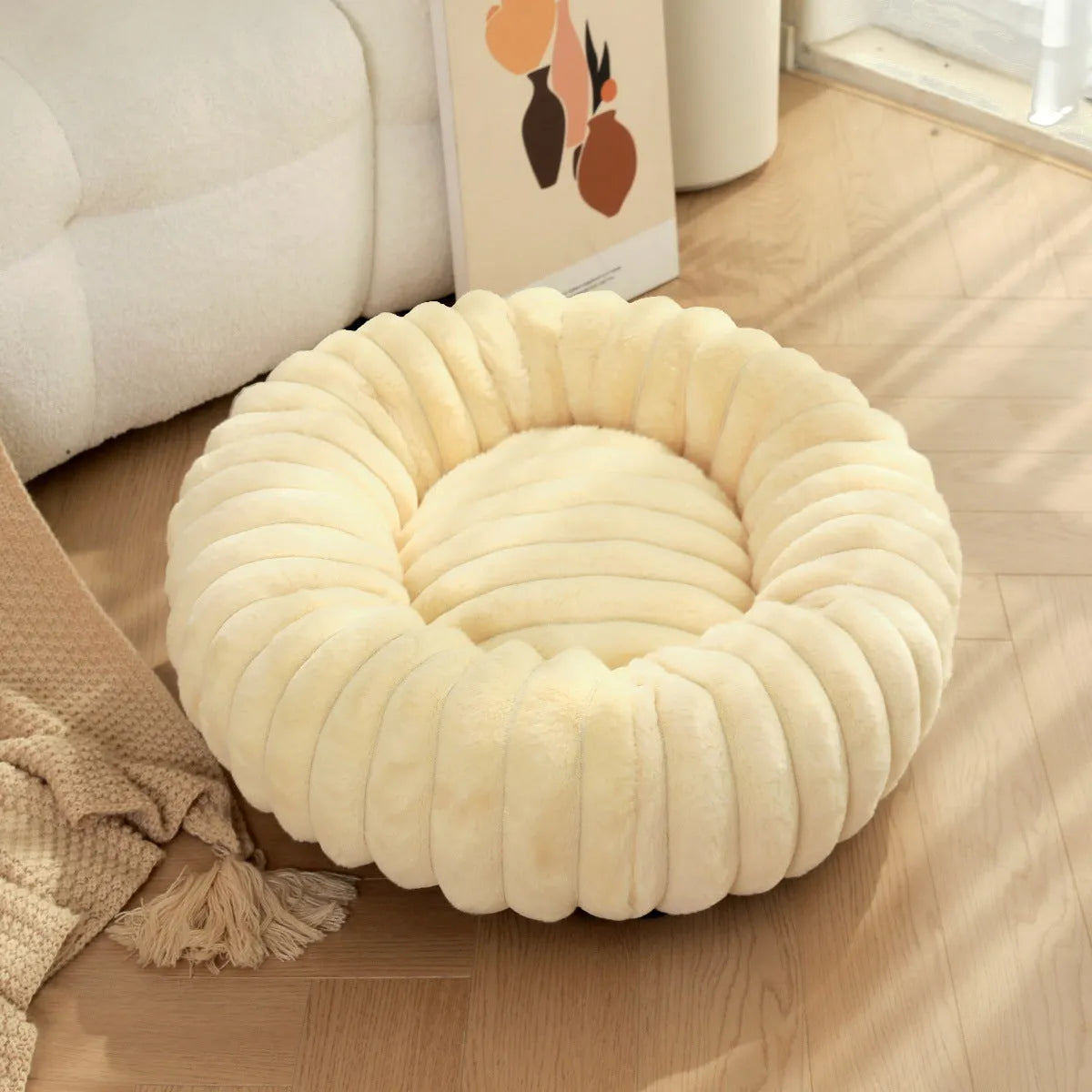 Round plush pet nest mat in beige, shown with a cat curled up inside.
