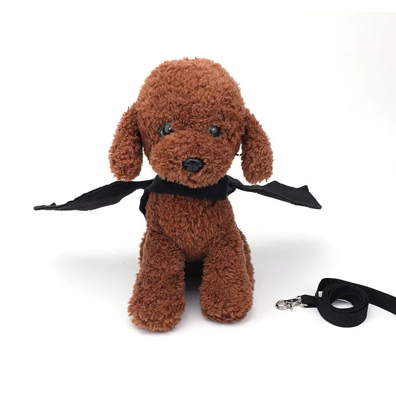 Black bat wing costume accessory for dogs showing chest and back attachment with optional traction rope