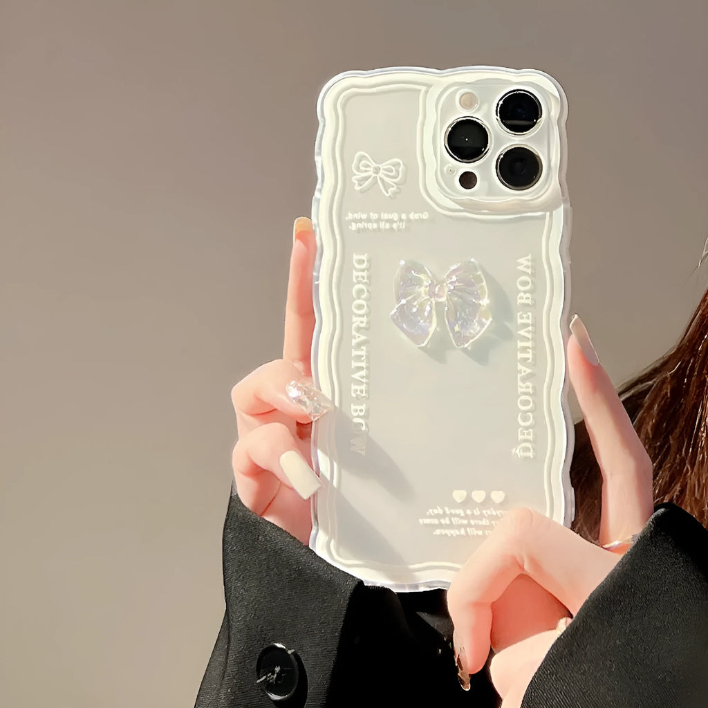 Transparent iPhone case with a raised 3D ice-through bow design on the back.