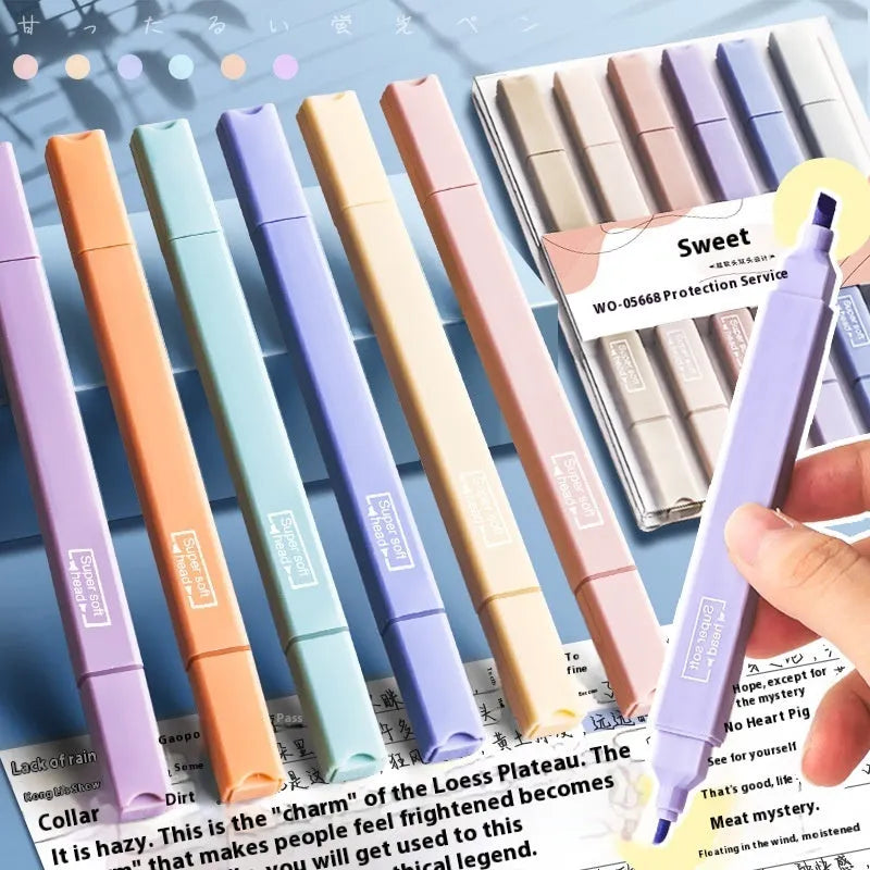 Set of double-ended fluorescent marking pens in assorted bright colours on a white background