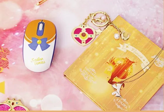 Pink Sailor Moon wireless mouse with cartoon character graphic, shown next to its small USB receiver.