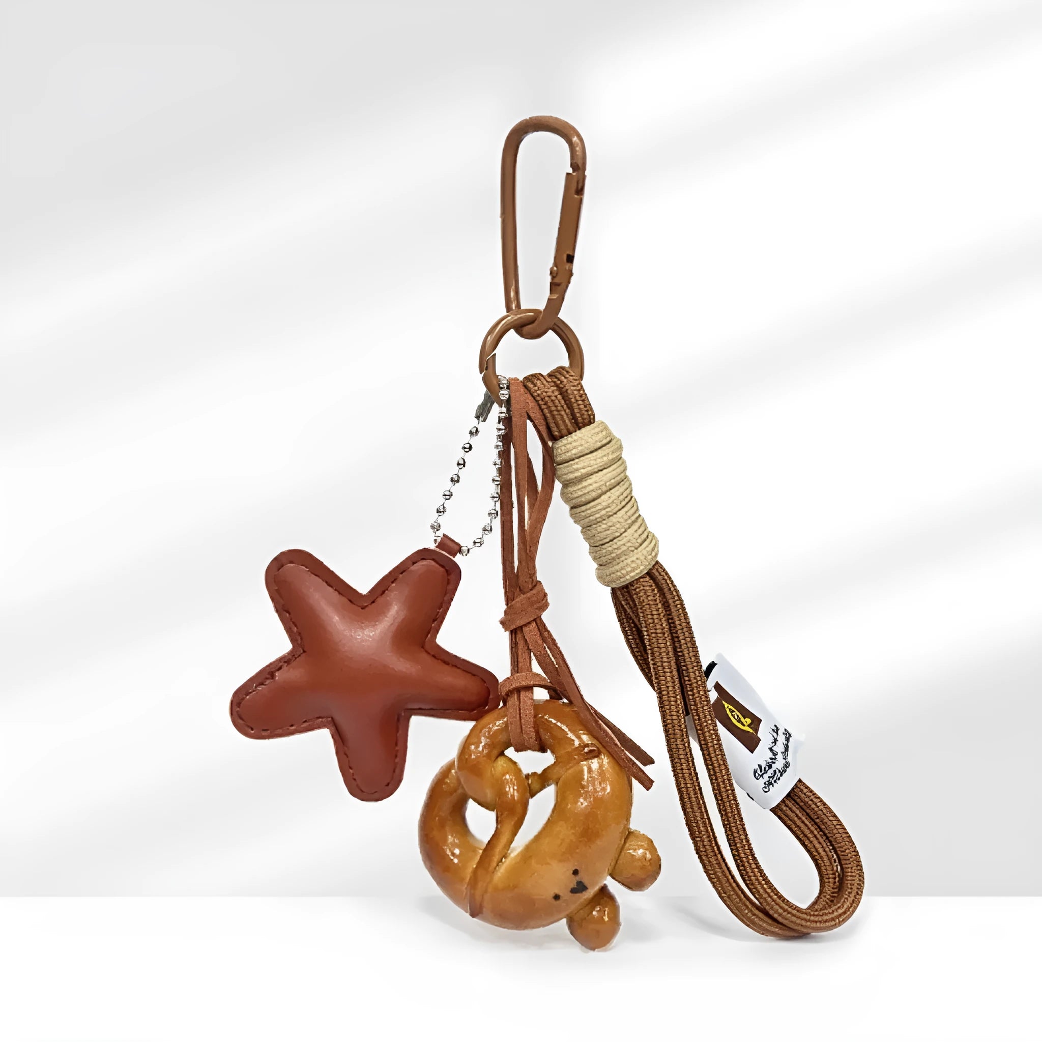 Handmade soda bread style handbag pendant with brown strap, showing cartoon croissant design.