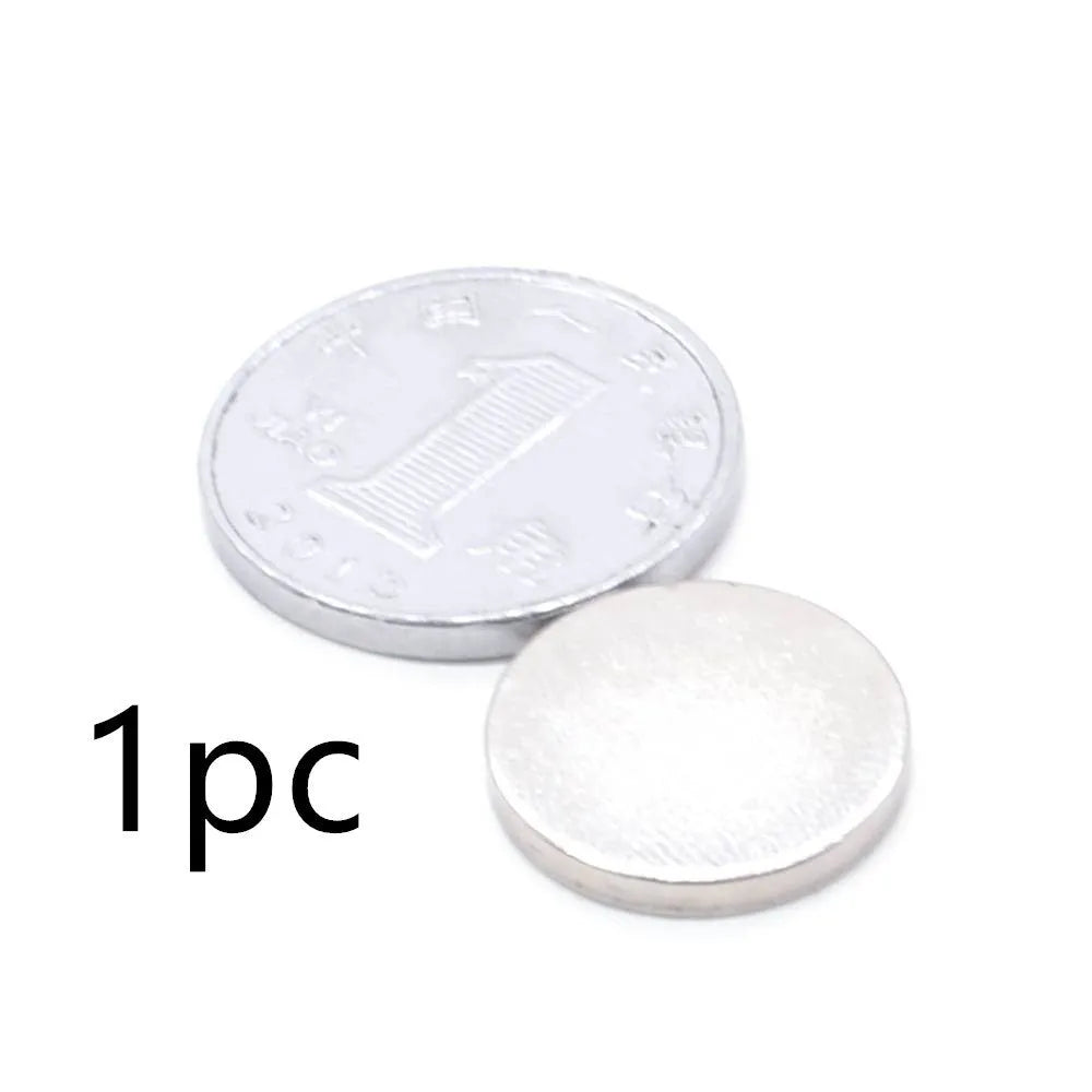 Silver neodymium magnet disc 14x2mm on plain background