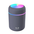 Mini ultrasonic essential oil diffuser with 300ml water tank in white, showing coloured night lights and USB cable