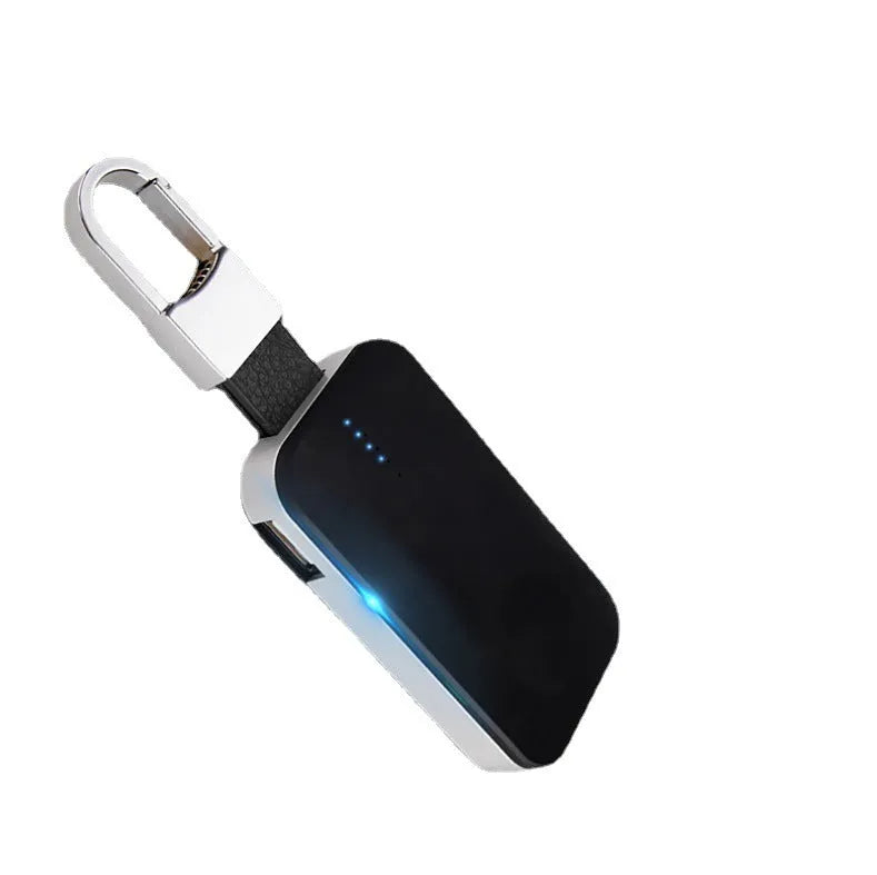 Black Apple Watch portable power bank keychain charger on a keyring.