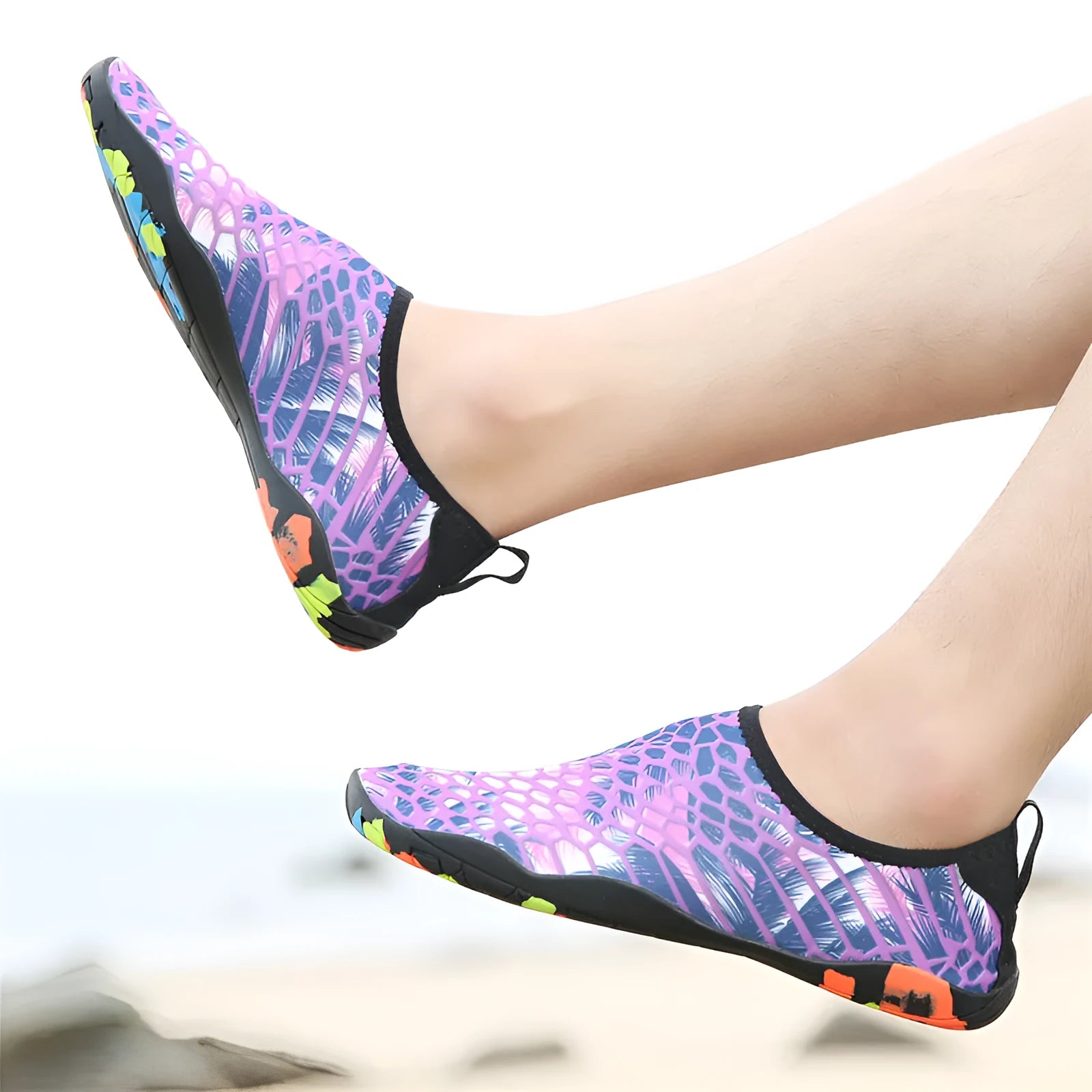 Blue Lycra beach wading shoes with decorative printing, shown on a sandy background