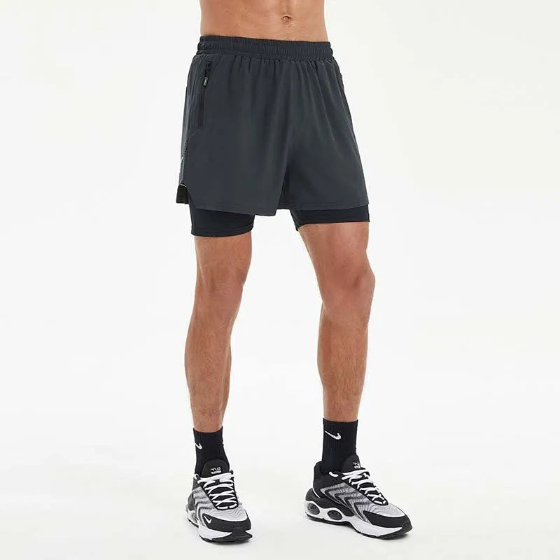 Men's black double-layer running shorts with inner liner on a man running outdoors.