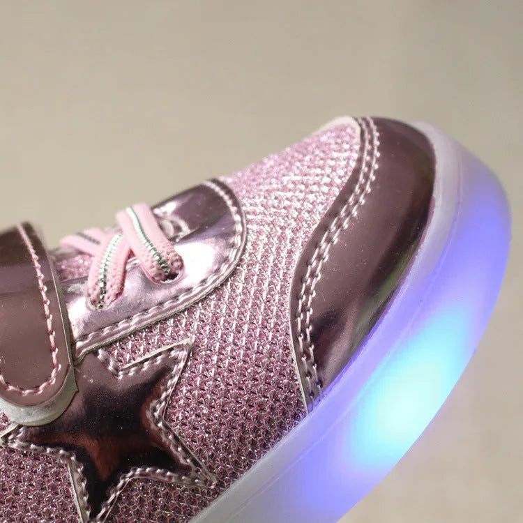 Golden children's LED sneakers with a light-up magic button on the heel