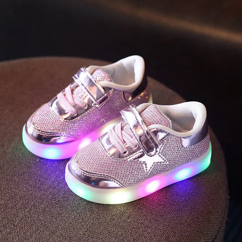 Golden children's LED sneakers with a light-up magic button on the heel