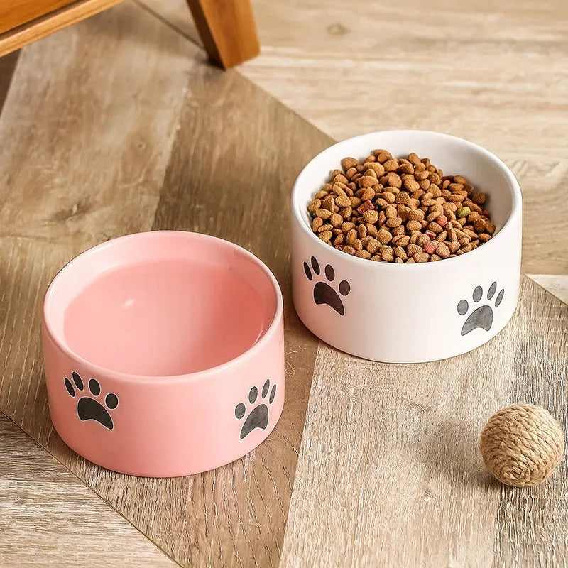 Ceramic high foot cat food bowl with cat paw print decoration in chosen colour