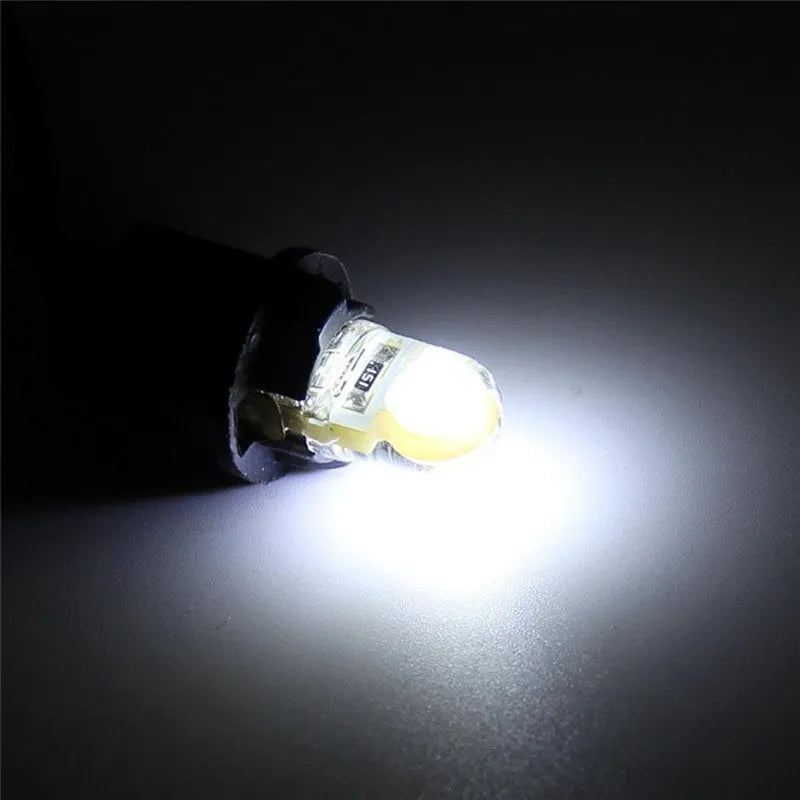 Pack of ten T10 wedge base LED bulbs for cars in seven different colours on a white background