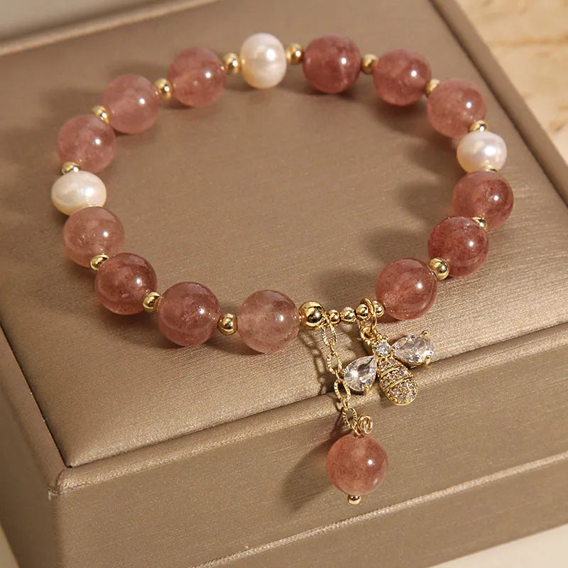 Women's bracelet with strawberry quartz beads, freshwater pearls, and metallic charms in Japanese Korean jewellery style
