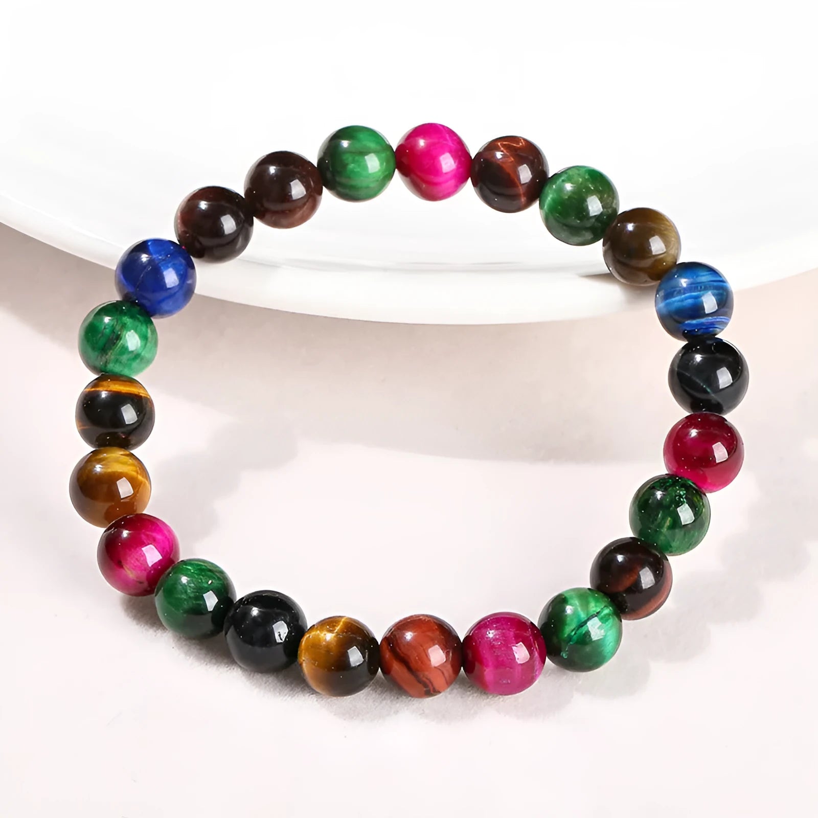 Colourful Tigereye stone bracelet with round beads on a mixed string, showing natural stone variations.
