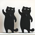 Set of two cartoon cat music themed iron bookends in black and white on a desk holding books upright