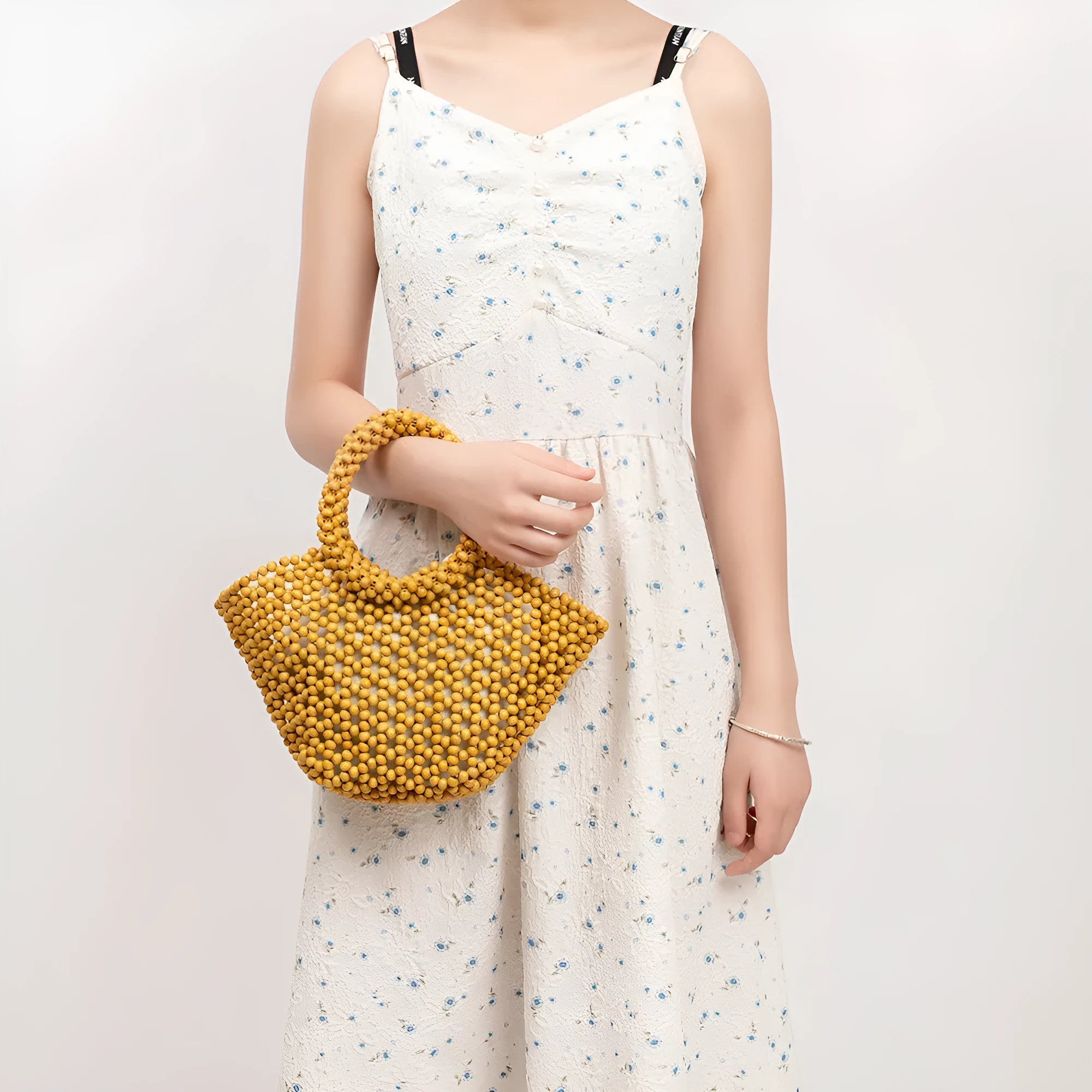 Hand-woven maple wood beach bag with wooden bead decoration in dumpling shape