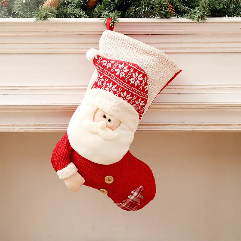 Large red and white knitted Christmas stocking with Santa Claus design hanging on a fireplace.