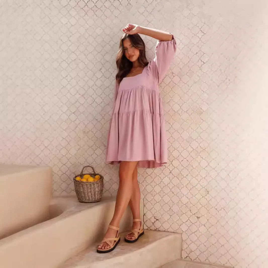 Girl in an orange red backless dress with a square collar and puff sleeves, showcasing the A-line skirt.