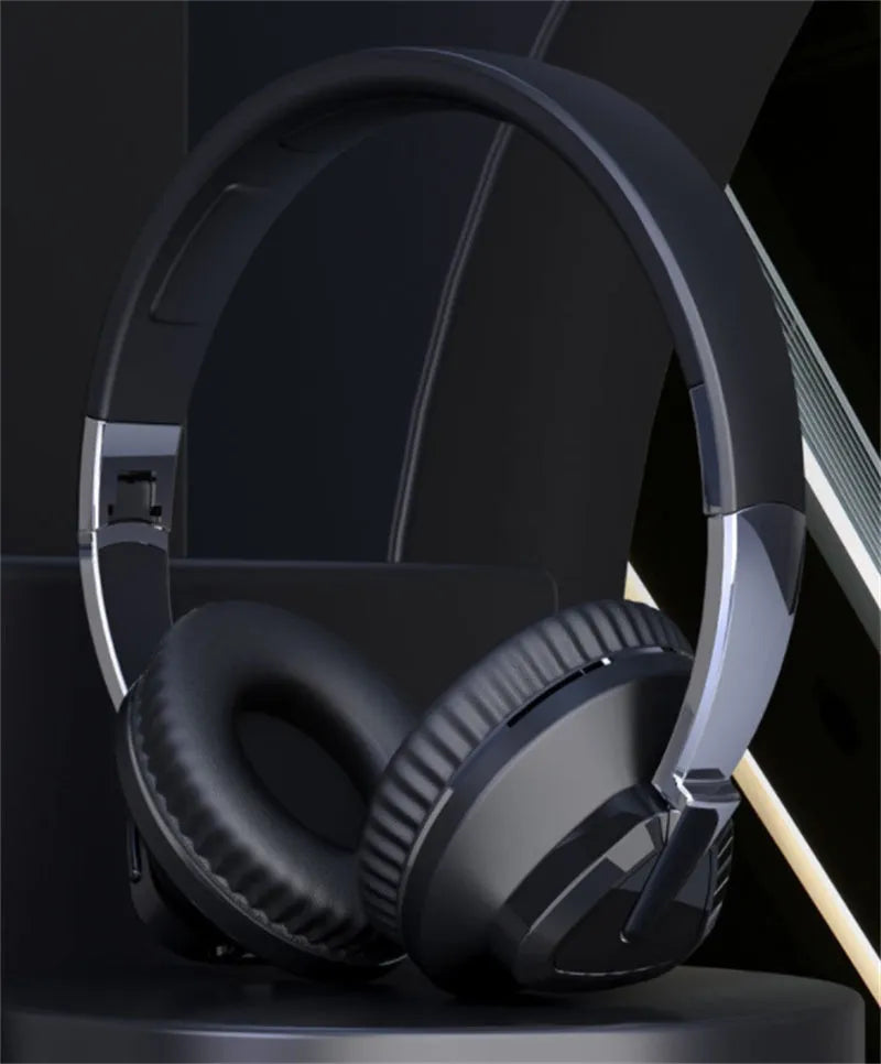 Black wireless over-ear headset with AUX cable and TF card slot, showing soft ear cups and control buttons.