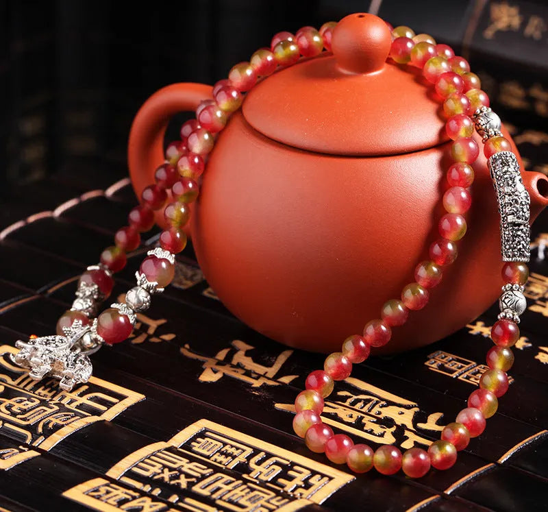 Watermelon crystal Chinese knot bracelet showing traditional design and natural crystal material