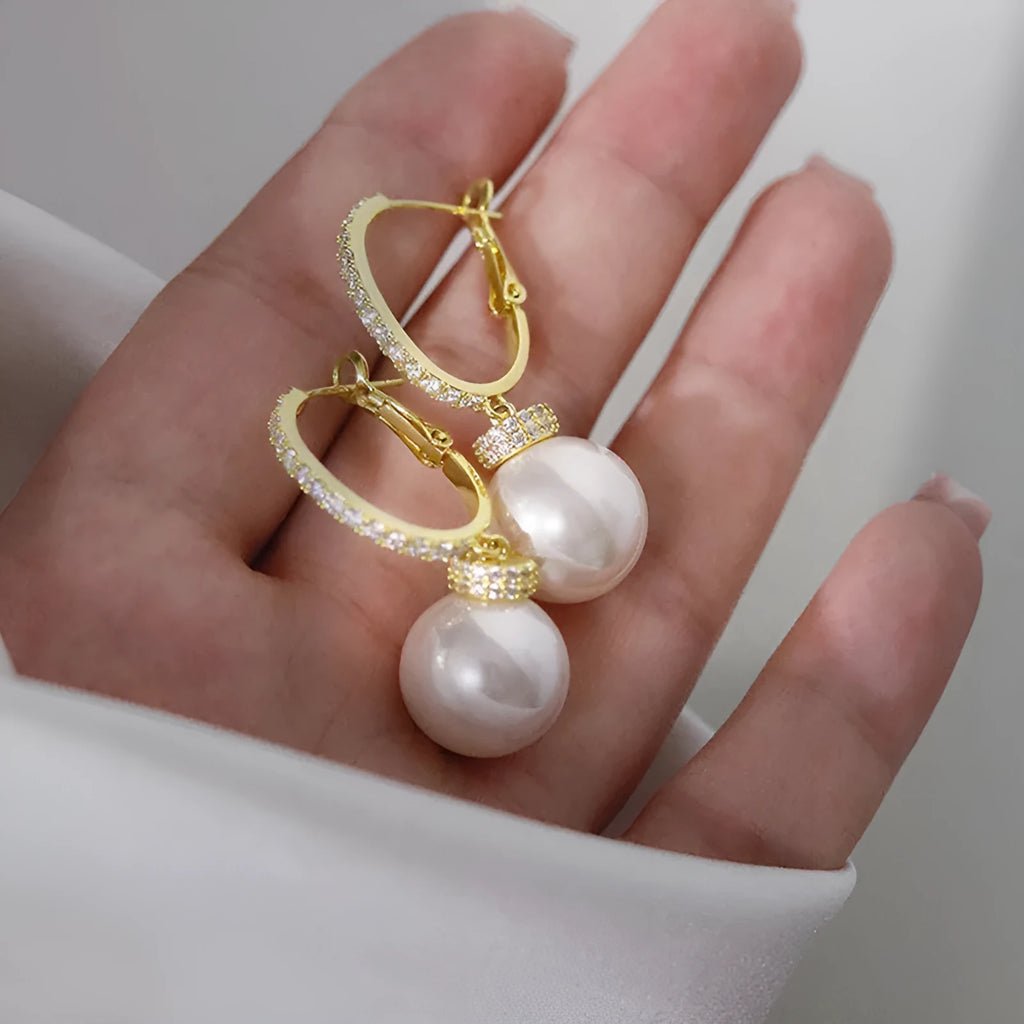 Yellow gold tone geometric earrings with imitation pearl and zircon inlay, round and ring design, one pair.