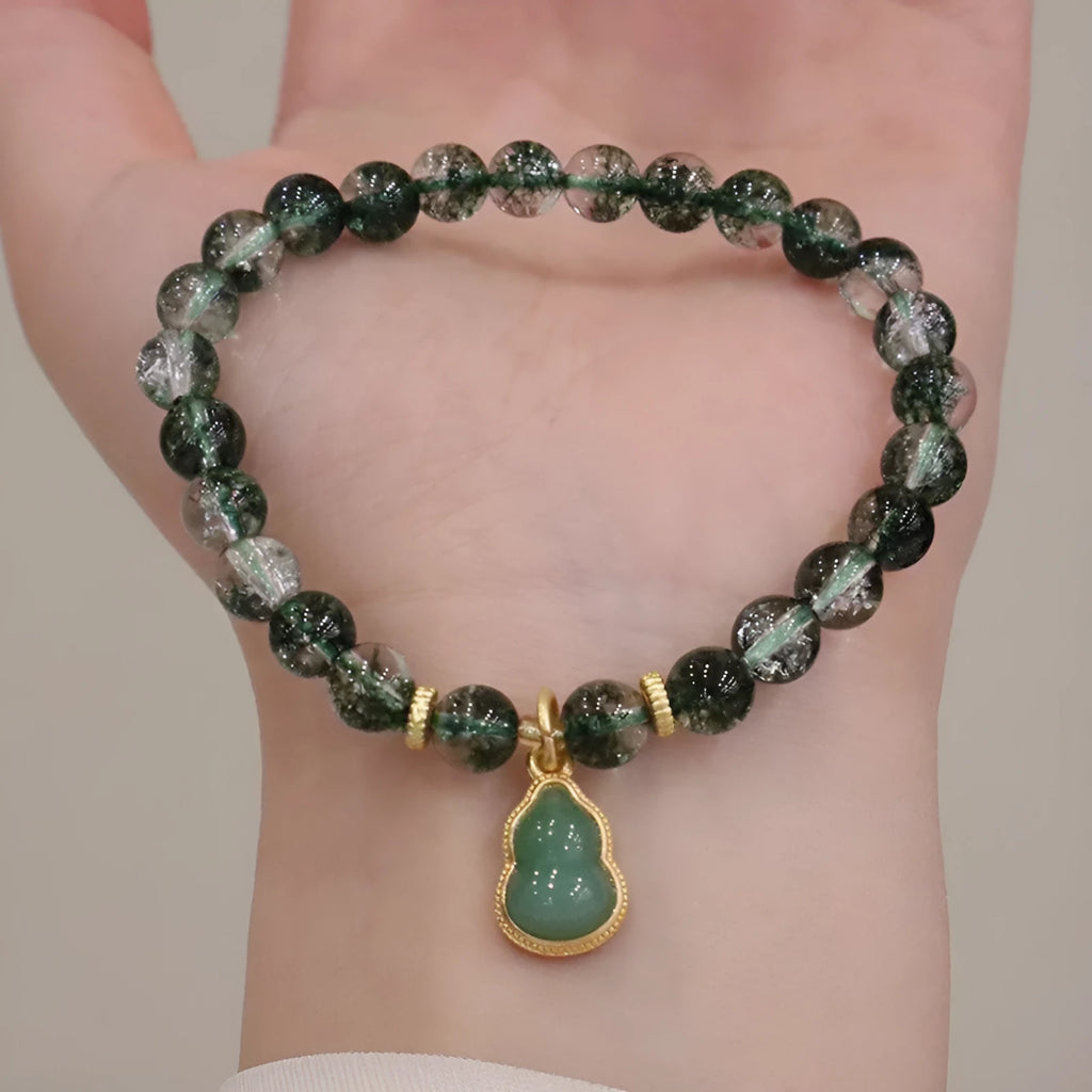 Women's handmade bracelet with citrine, chorite crystal, a green phantom quartz calabash pendant, and pearl accents.