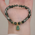 Women's handmade bracelet with citrine, chorite crystal, a green phantom quartz calabash pendant, and pearl accents.