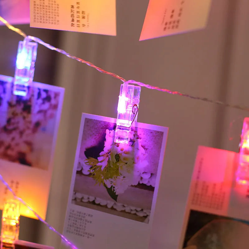 LED decorative light string with white heart-shaped clips spaced along its length, illuminated with warm white LEDs.