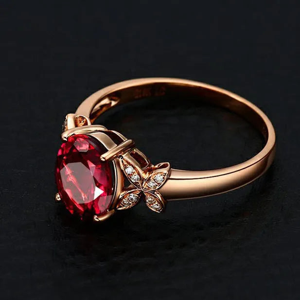 Women's butterfly and heart-shaped ring in copper with rose gold plating shown in red and blue colour options