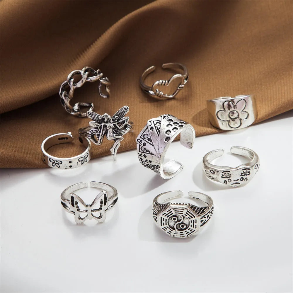 Geometric alloy ring with butterfly and snake motifs in retro style on finger
