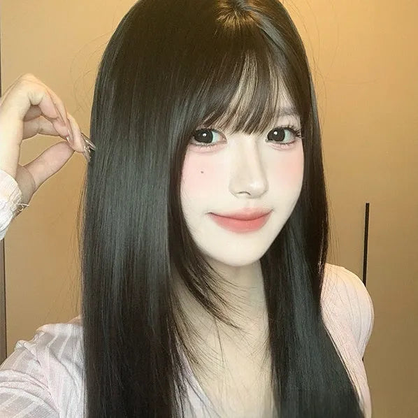 Dark brown long straight synthetic wig with bangs on a wig head.