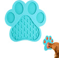 Blue bone-shaped silicone dog licking mat with suction cups on the back, placed on a tiled wall.