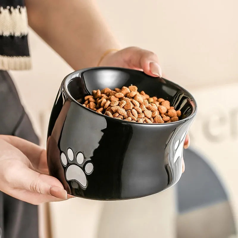 Ceramic high foot cat food bowl with cat paw print decoration in chosen colour