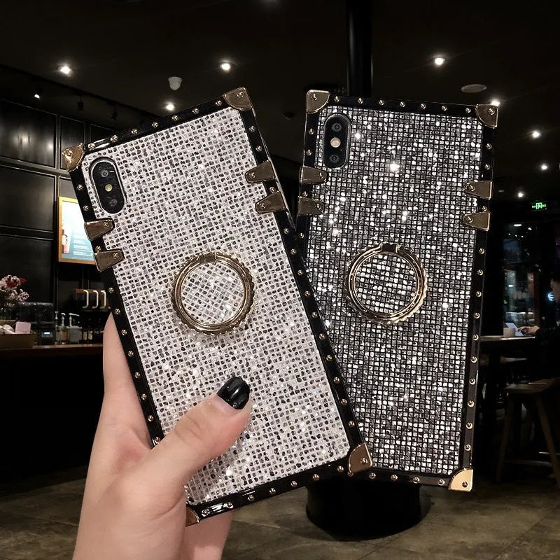 Square clear TPU mobile phone case with a silver flash diamond bracket on a smartphone.