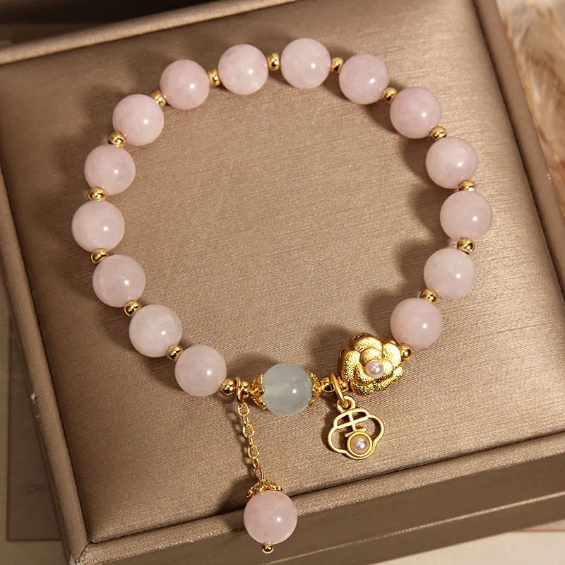 Close-up of a women's pink crystal flower bracelet on an adjustable chain.