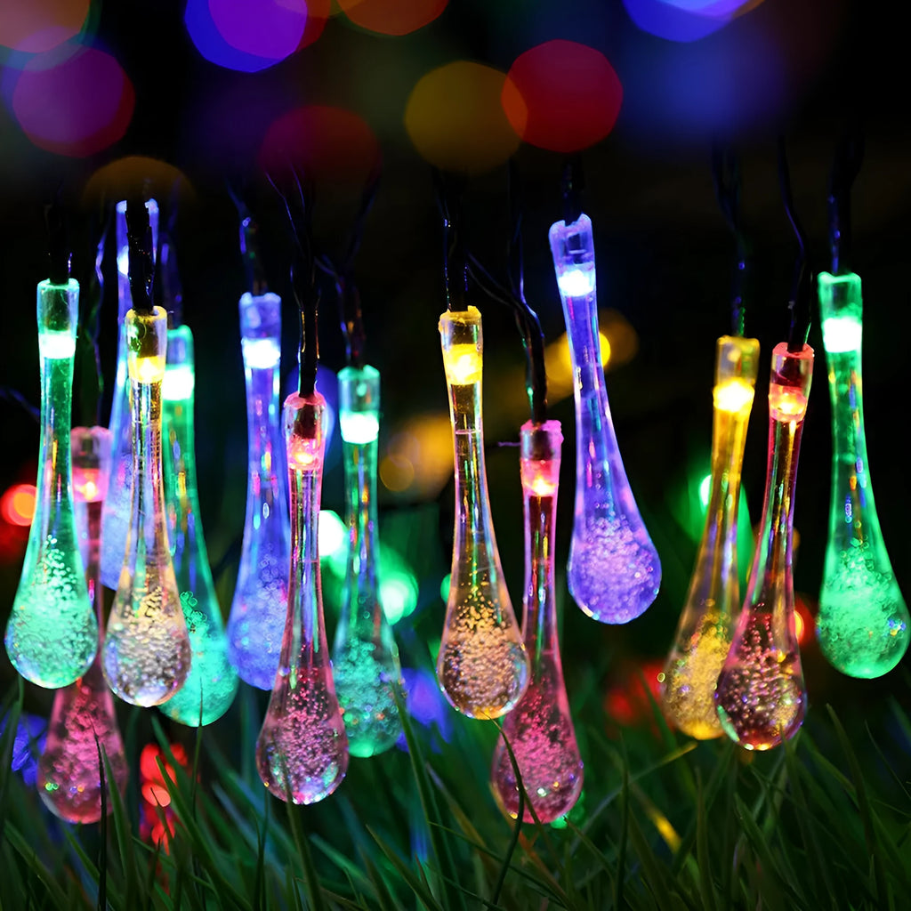 6.5 metre solar LED outdoor string lights with water drop bubble pendants in garden setting