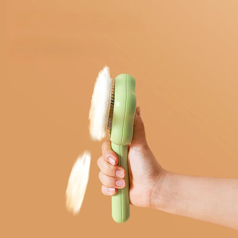 Green self-cleaning cat comb with four stainless steel needles measuring 20cm long