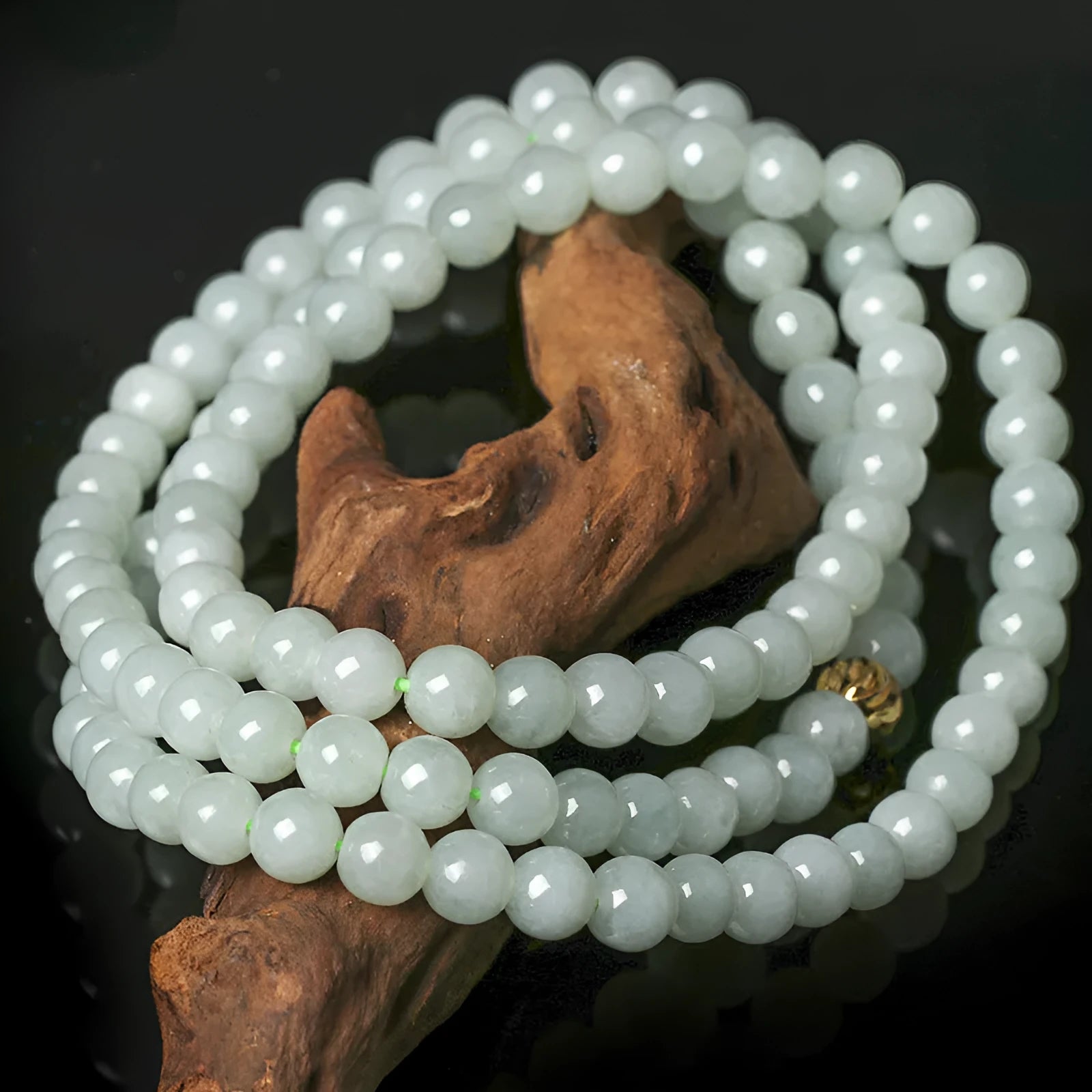 Natural white-green jade bead necklace with adjustable chain and 6.5mm round beads on grey background