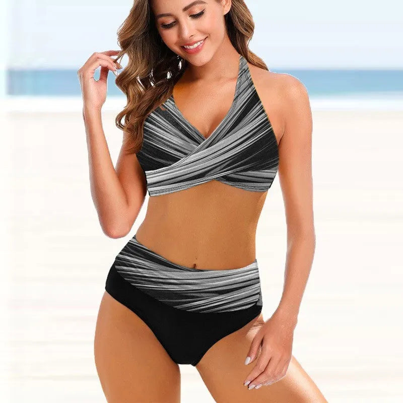 Women's striped tie-dye bikini set with hollow design and high-waisted briefs on a model.