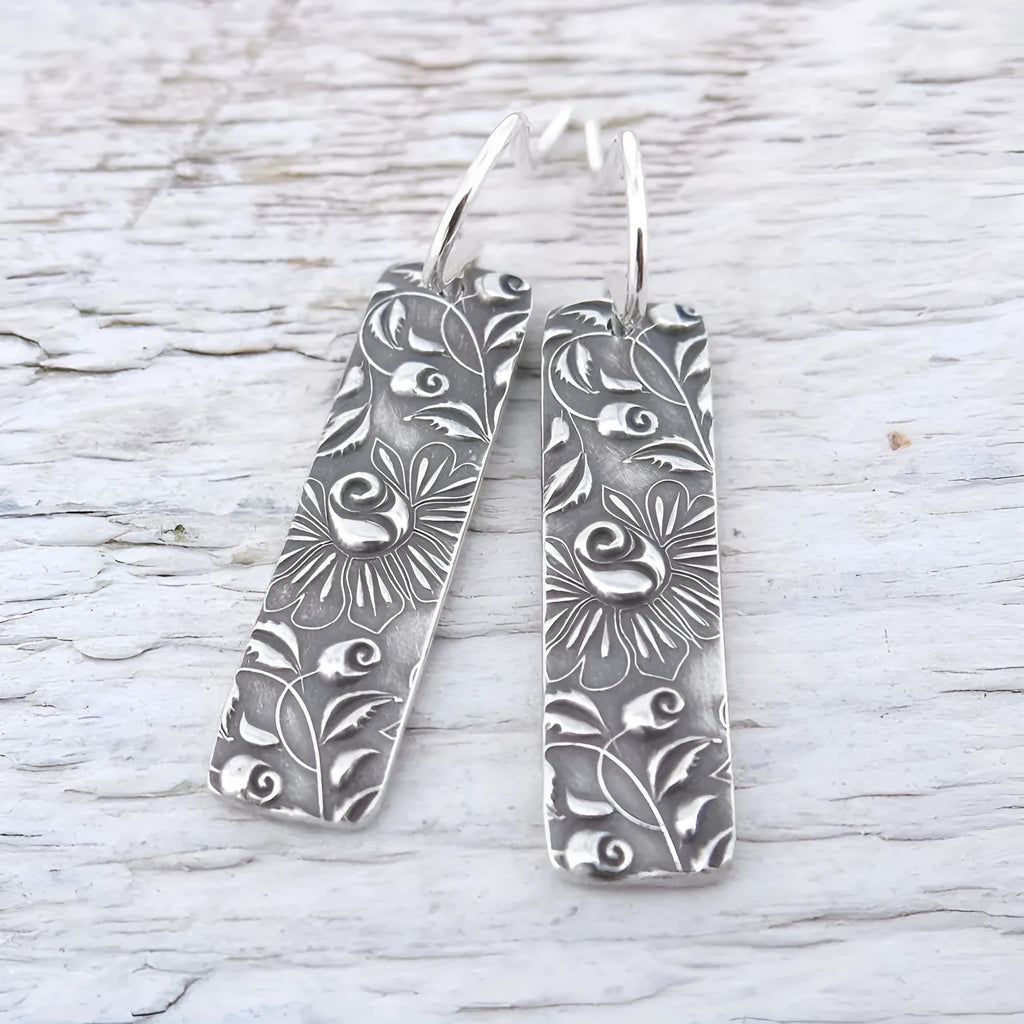Silver geometric long earrings with a carved vine pattern in a retro style